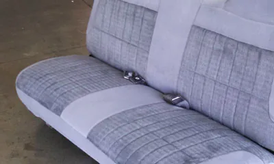 Reupholstered gray cloth bench seat